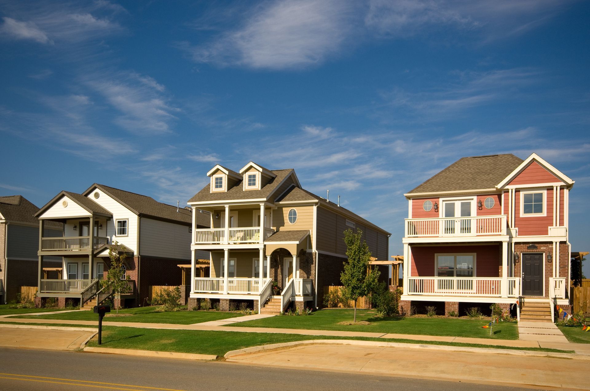 A row of houses with a blue sky in the background