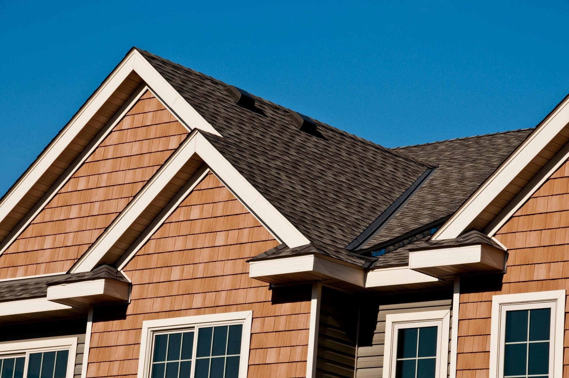 The roof of a house with a blue sky in the background