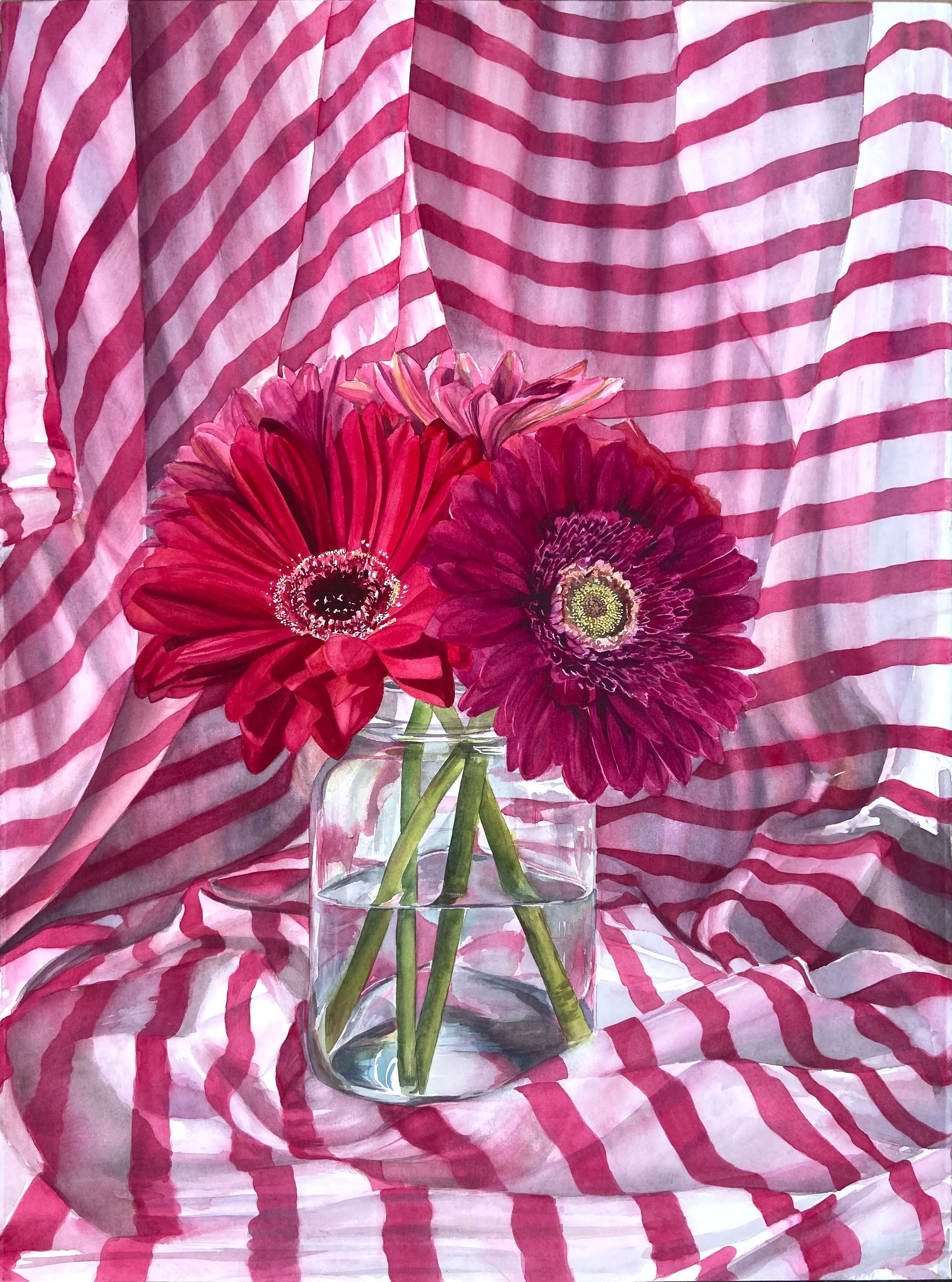still life painting of pink gerbera daisies in clear vase surrounded by pink striped fabric.