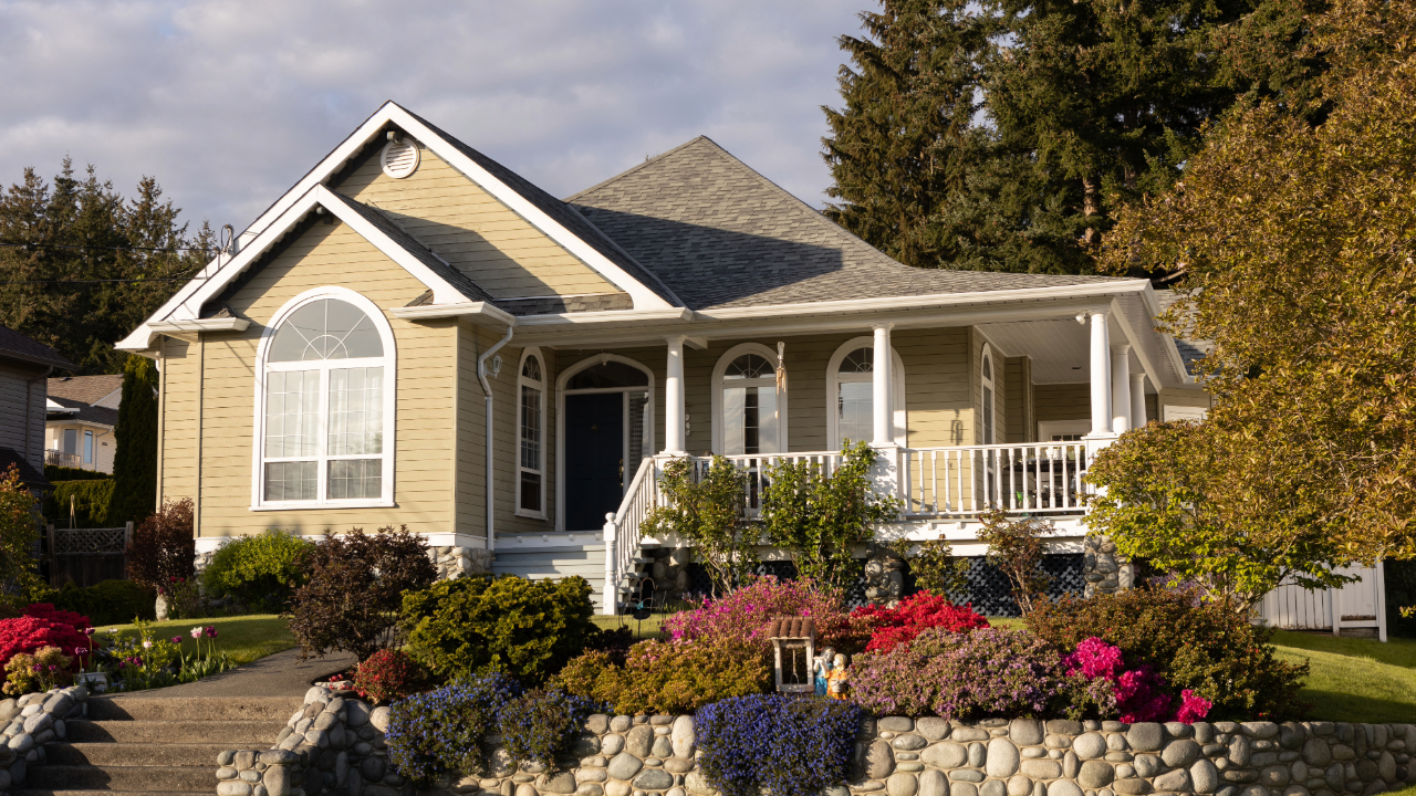 A large house with a stone wall in front of it