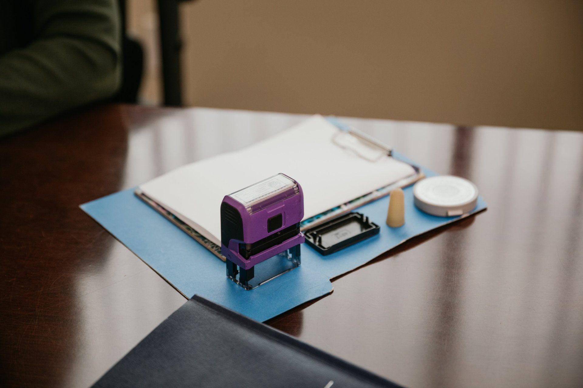 Miniature purple tram and tiny objects on a blue board atop a wooden table