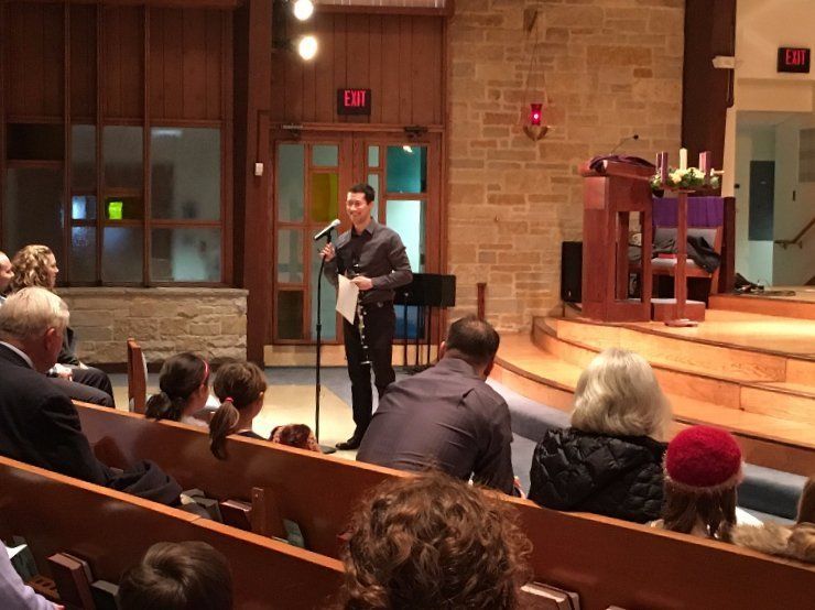 Man speaking at a podium in a church, audience seated in pews.