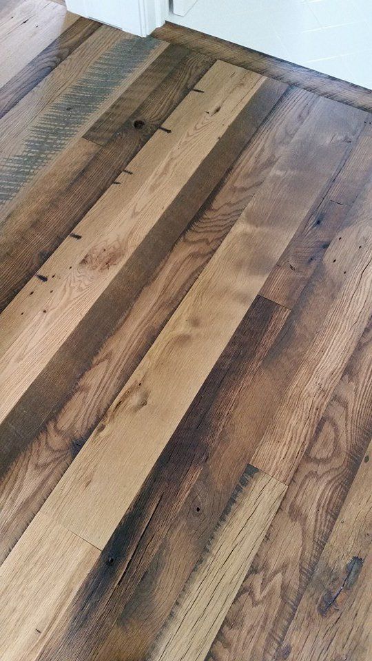 Close-up of a hardwood floor with varying shades of brown and natural wood grain.