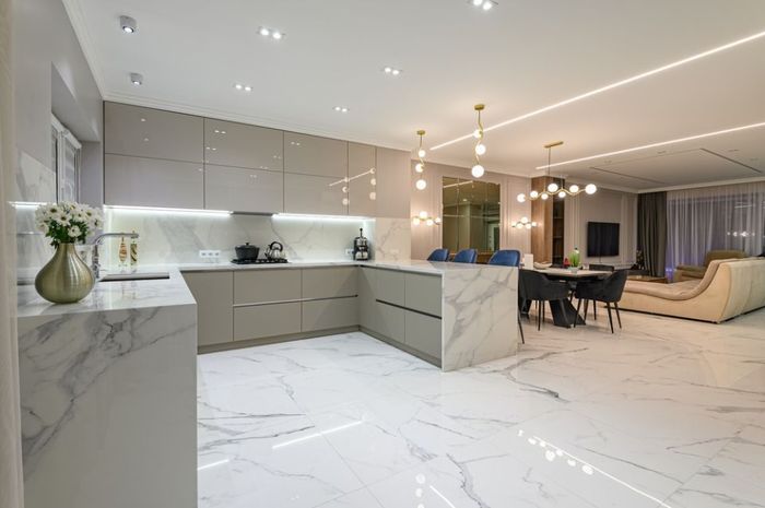 kitchen and dining room in a modern house with marble floors.