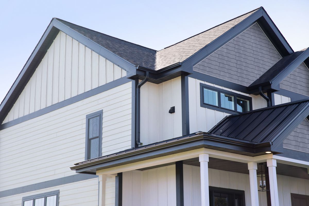 New suburban home with white siding and black trim.