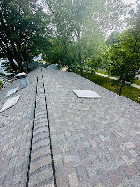 Construction of a house roof using metal tiles.