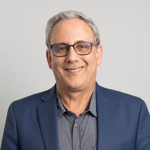 group of people taking a picture with an award