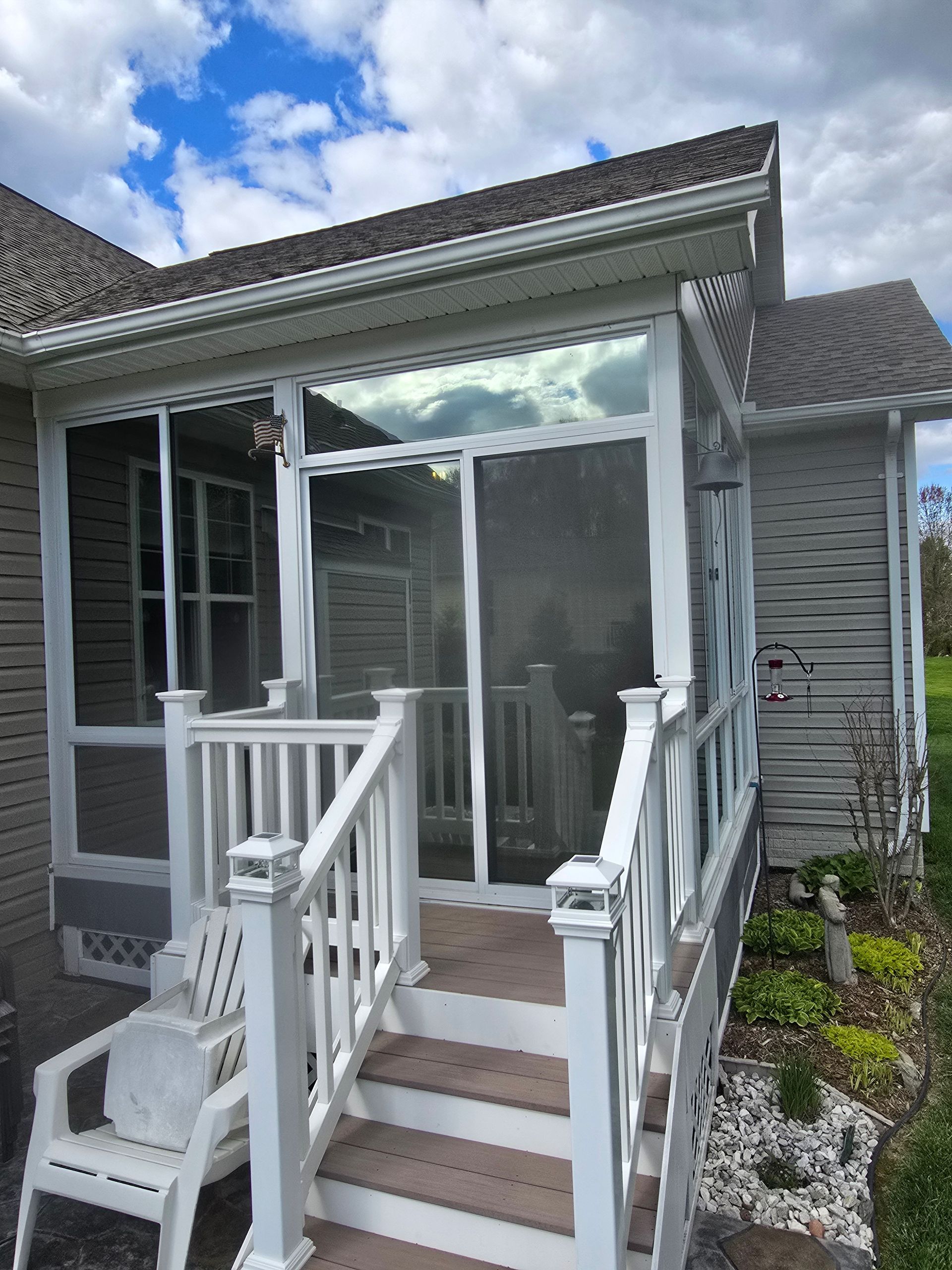 A screened in porch with stairs leading up to it