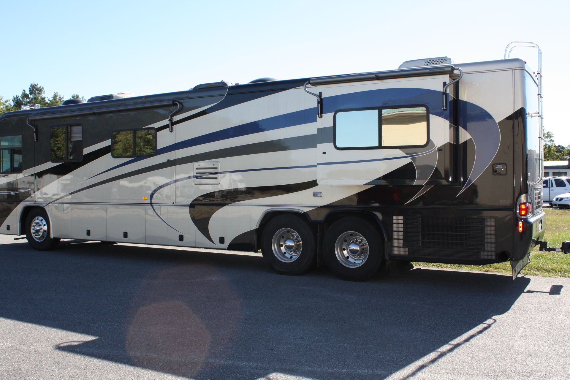 A man is working on a black lexus car