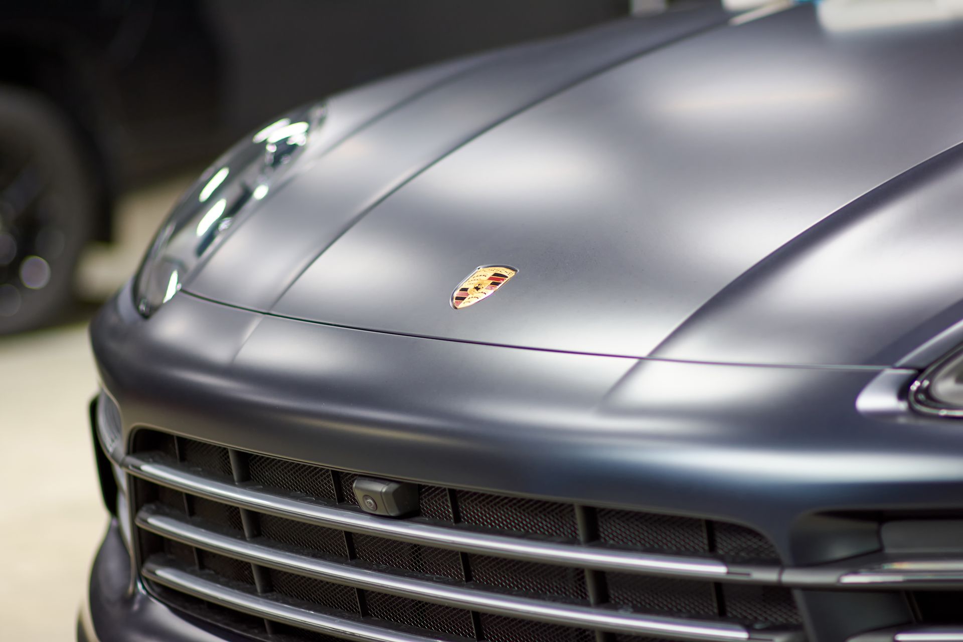 A close up of the front of a porsche car.