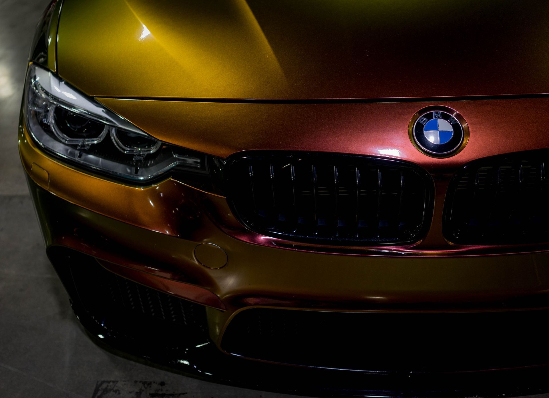 A close up of a bmw car parked in a garage.