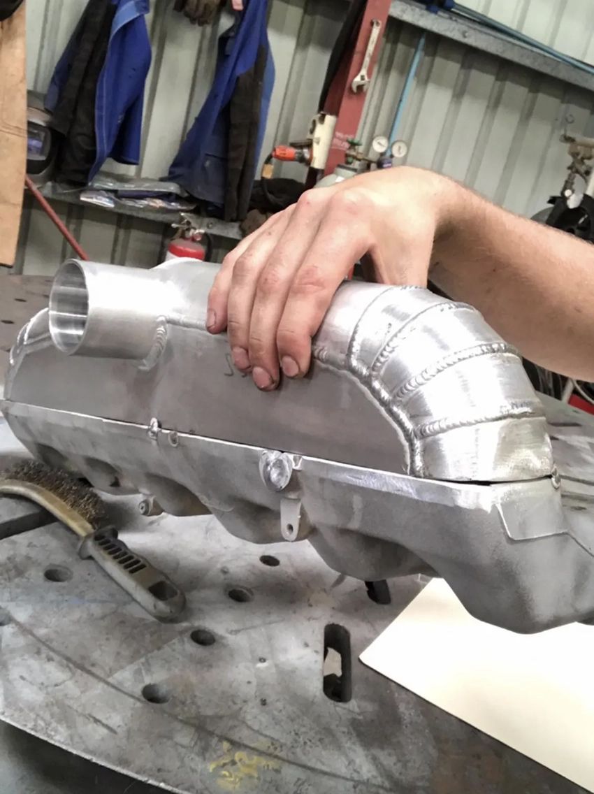 A Person is Holding a Piece of Metal in Their Hand — Hardarc Engineering in Coolum Beach, QLD