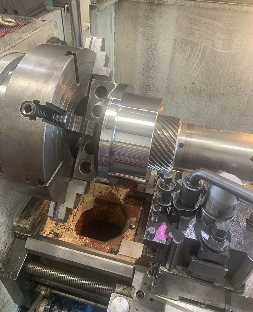 A Lathe is Being Used to Cut a Piece of Metal — Hardarc Engineering in Noosa, QLD