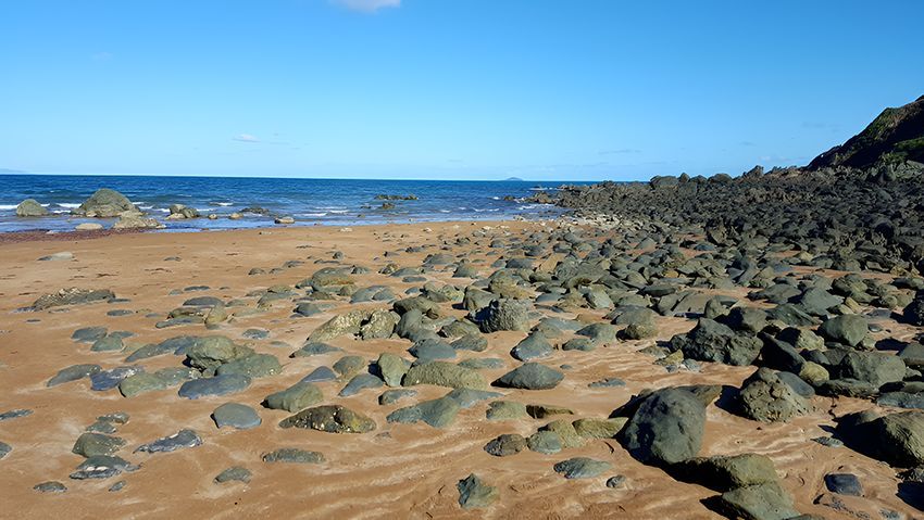 A Rocky Beach With a Large Body of Water — Hardarc Engineering in Mackay, QLD