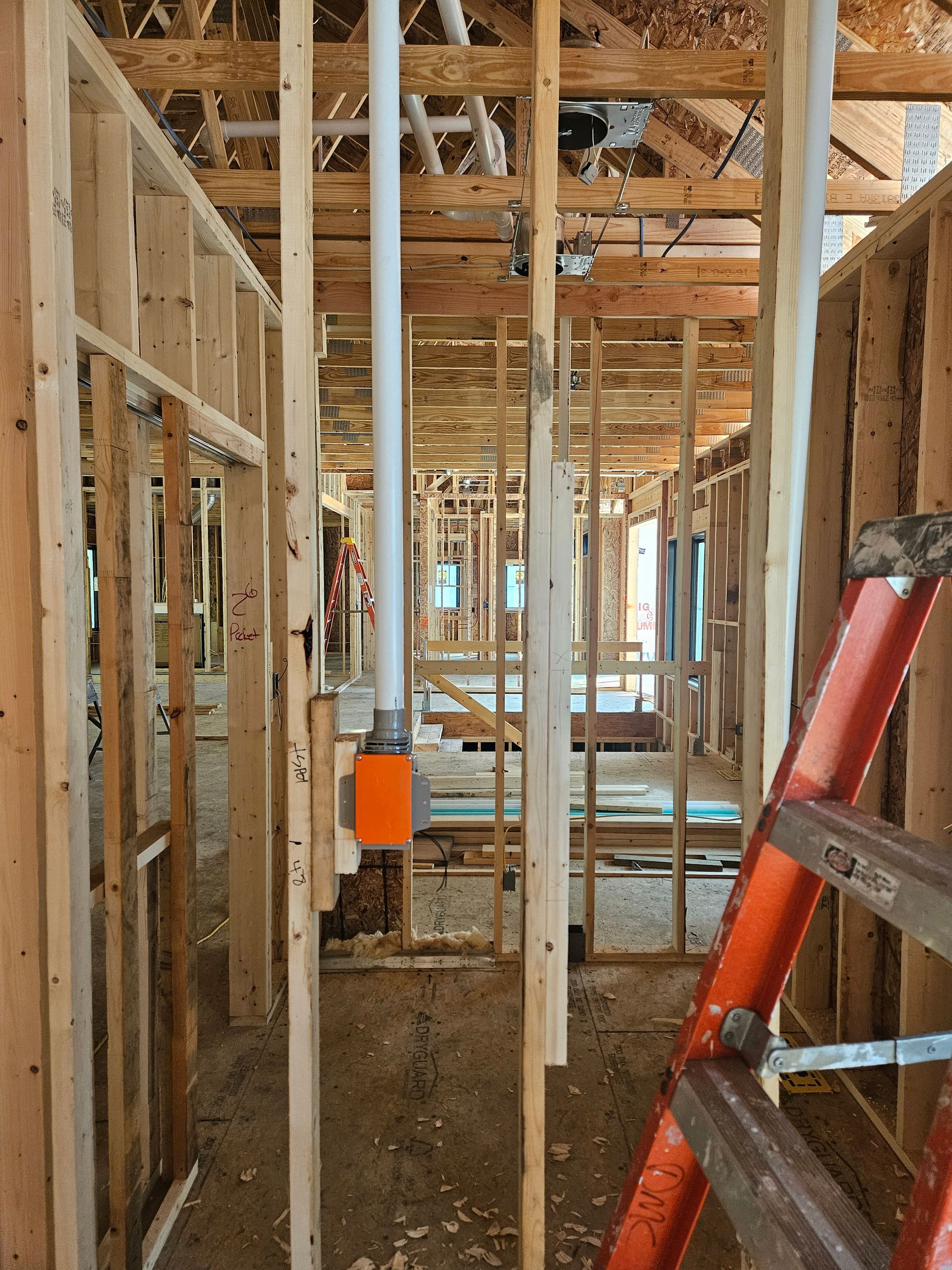 A ladder is sitting in the middle of a building under construction.