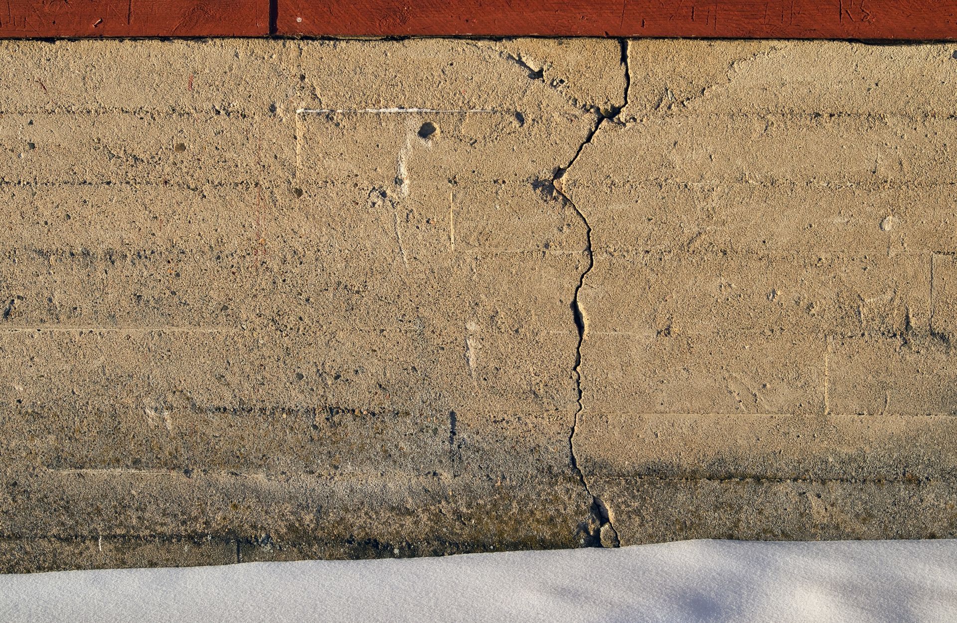 Crack in the foundation of a house. Crack in the foundation of a house.