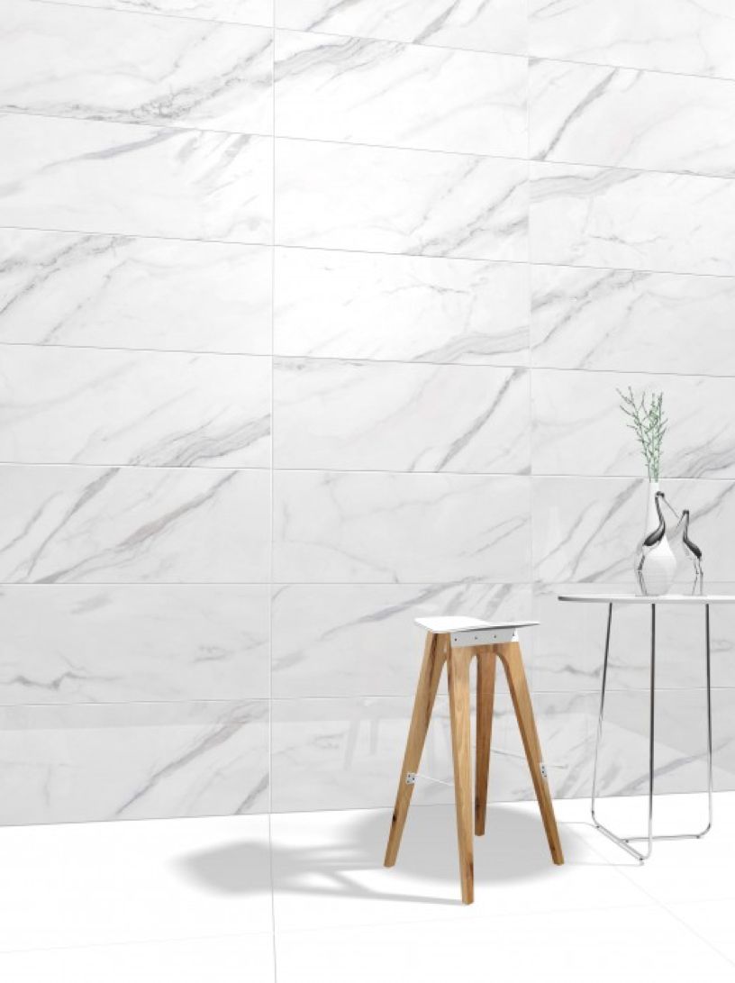 A Wooden Stool Is Sitting In Front Of A White Marble Wall — Mid Coast Tiles Urunga In Urunga, NSW