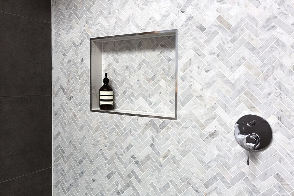 A Bottle Of Soap Is Sitting In A Niche In A Shower — Mid Coast Tiles Urunga In Urunga, NSW