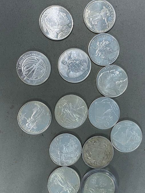 A bunch of coins are sitting on top of each other on a table.