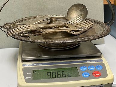 Silverware is sitting on top of a digital scale.