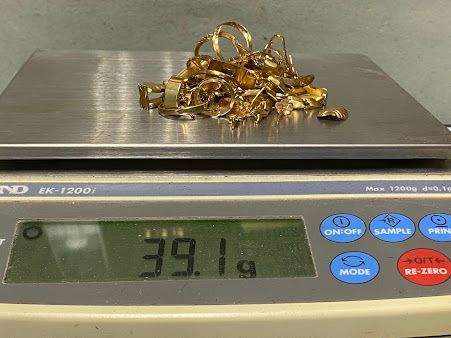 A pile of gold is sitting on top of a scale.