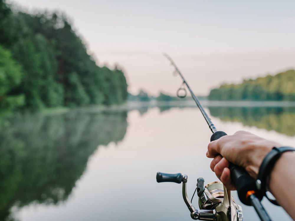 A Man Fishing on a Lake