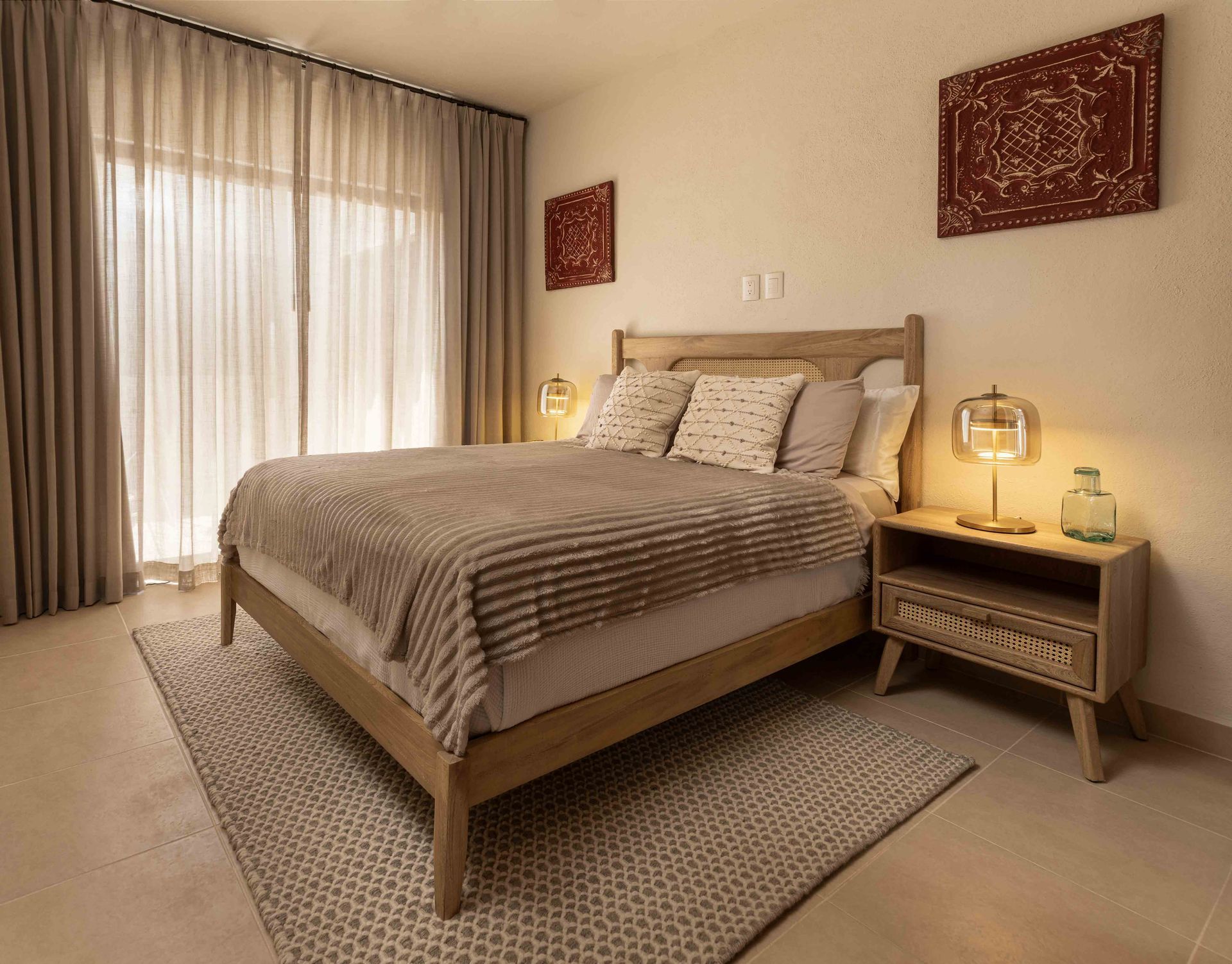 A bedroom with a large bed , nightstand , and rug.