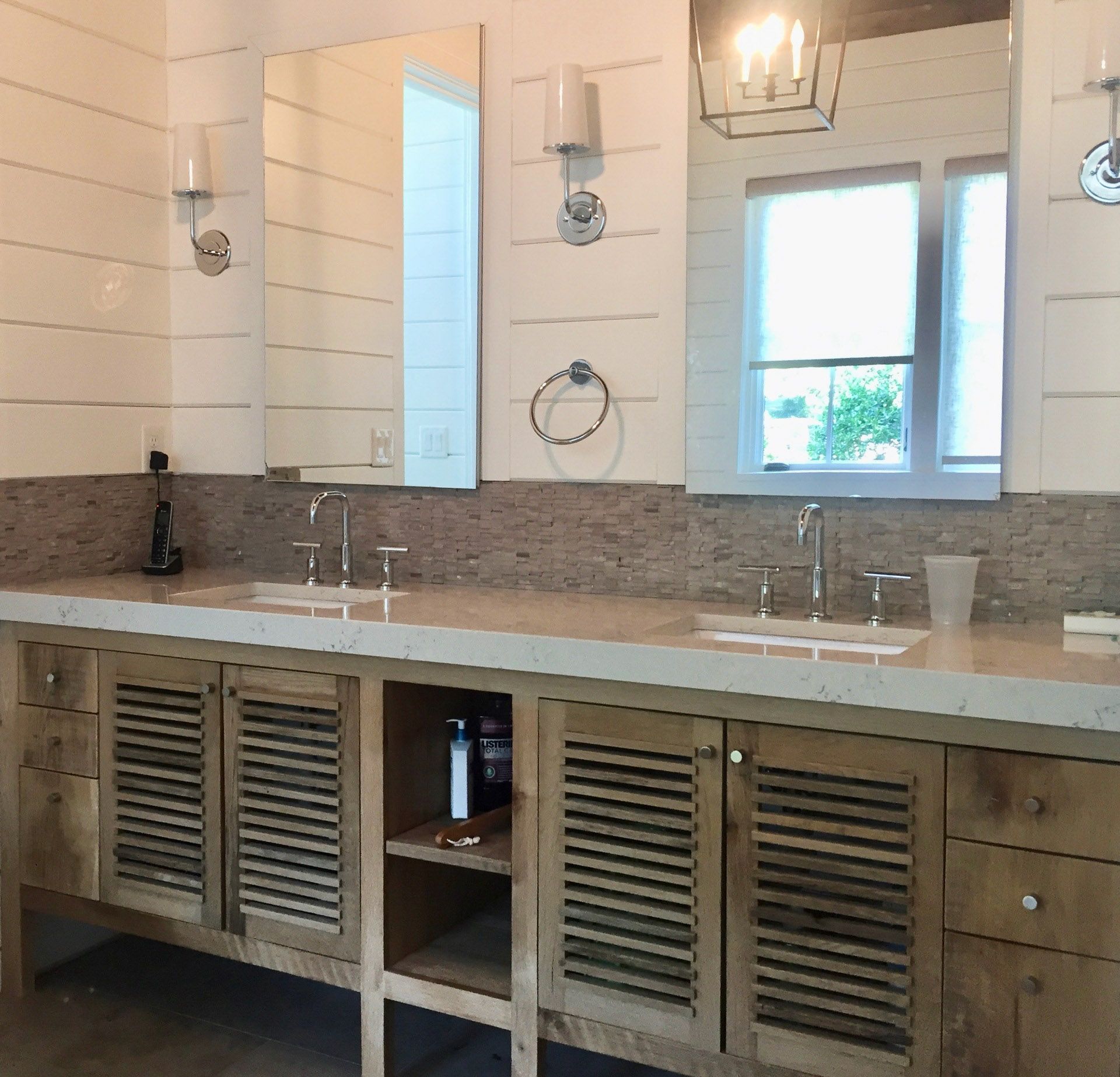 A bathroom with two sinks and two mirrors