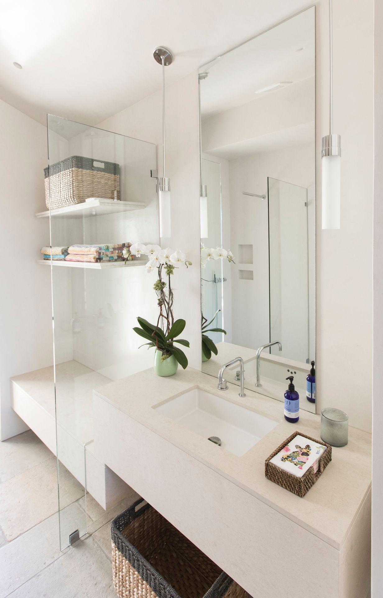 A bathroom with a sink and a large mirror