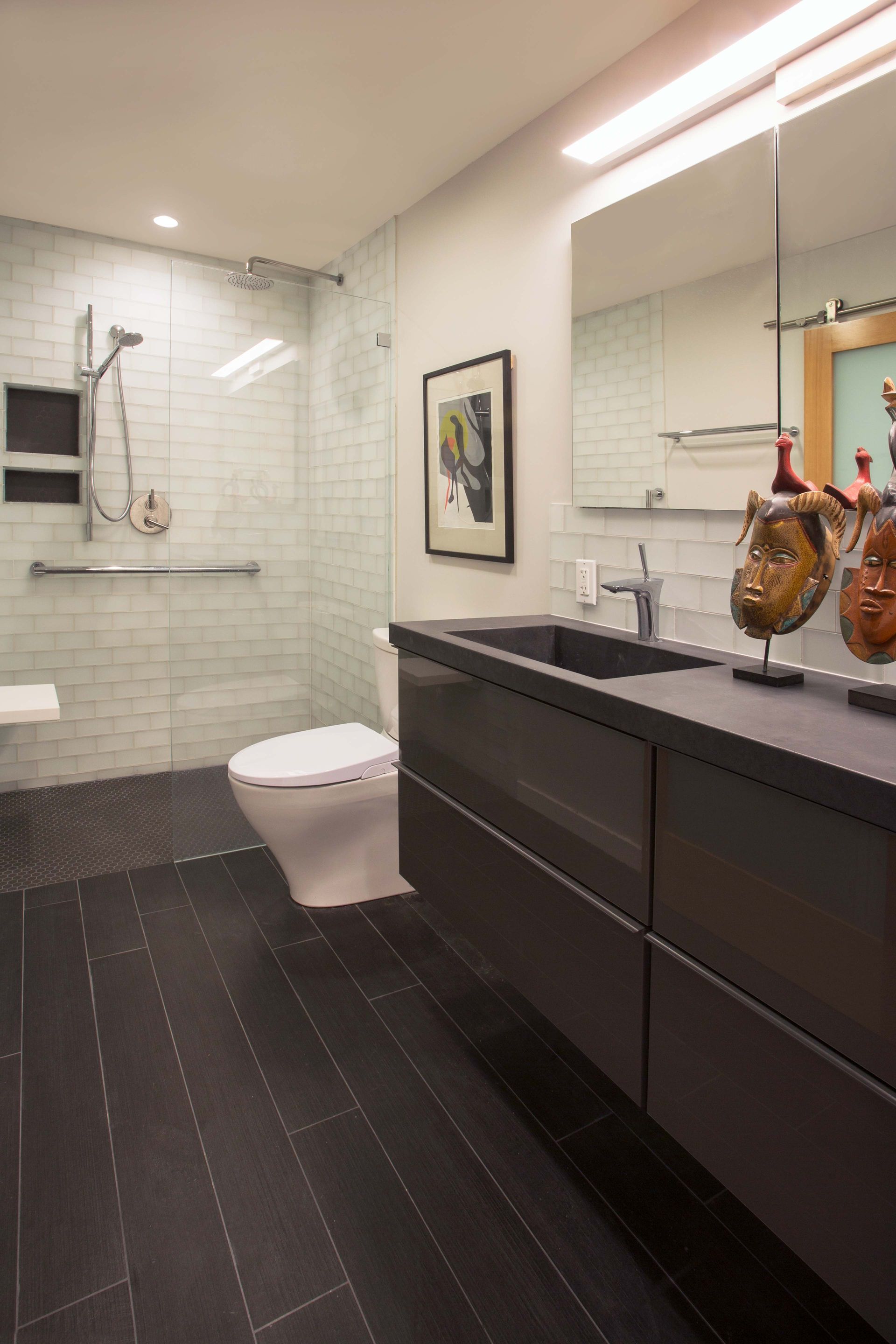 A bathroom with a toilet , sink and mirror
