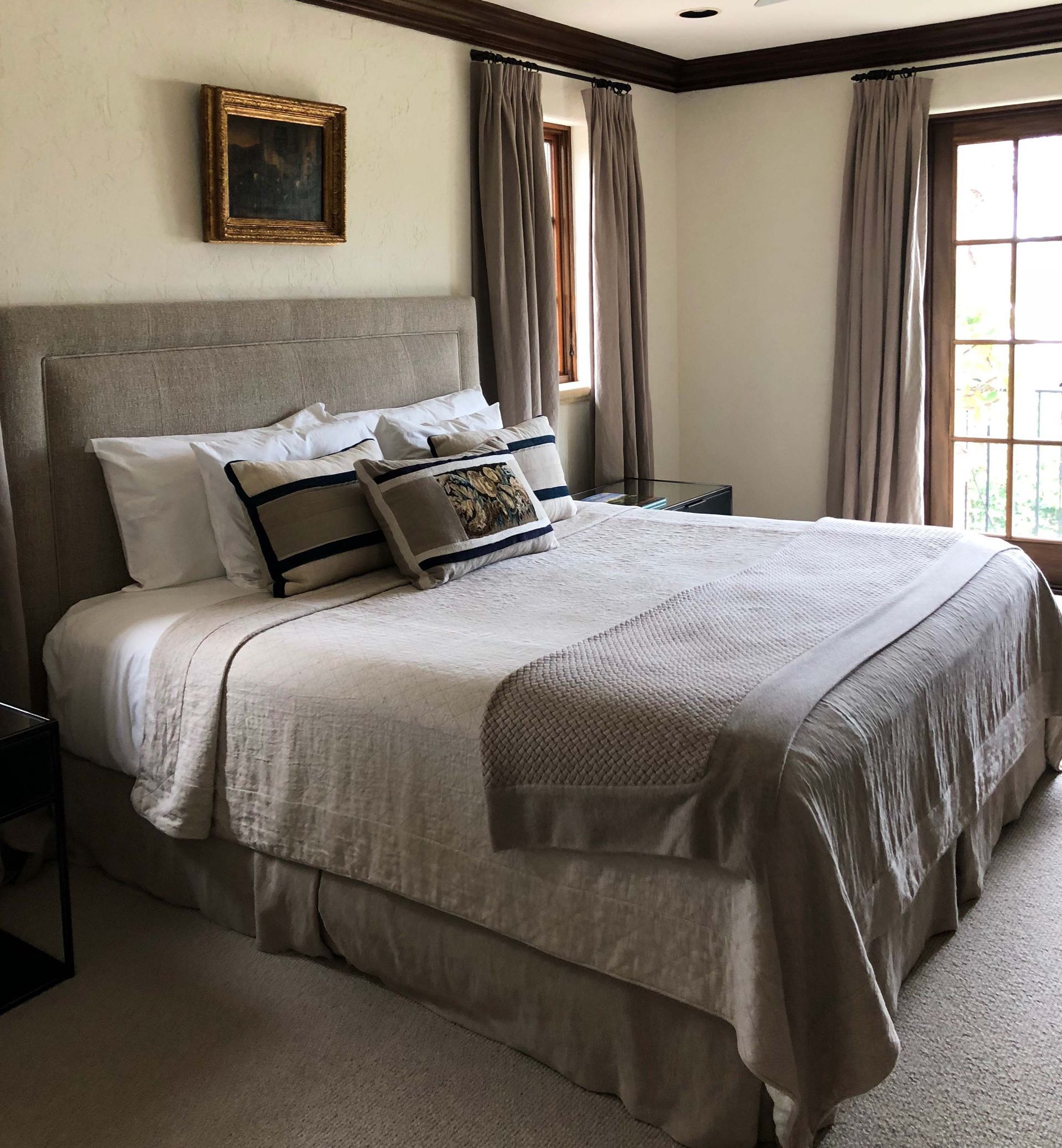 A bedroom with a large bed and a window
