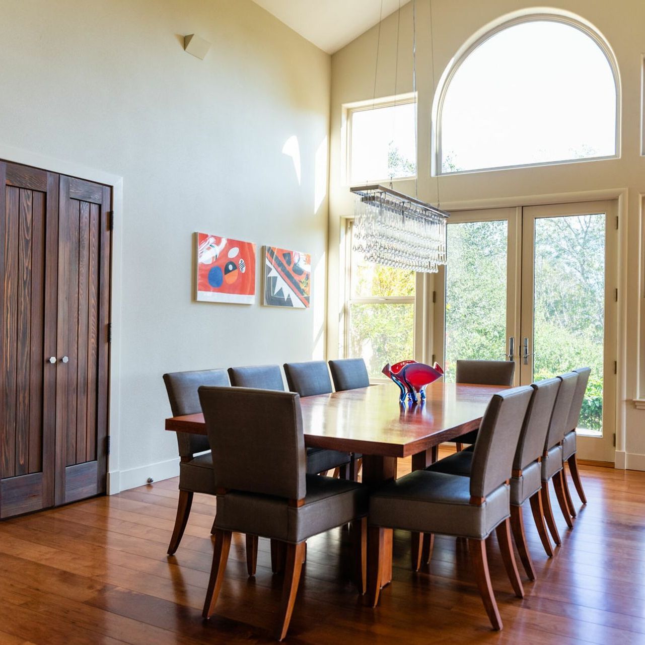 A dining room with a long table and chairs