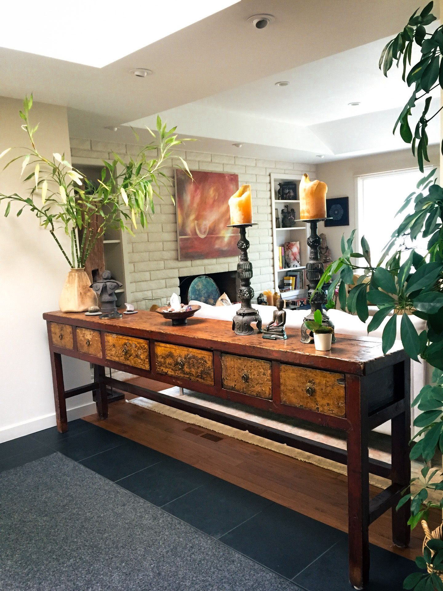 A long wooden table with drawers in a living room.