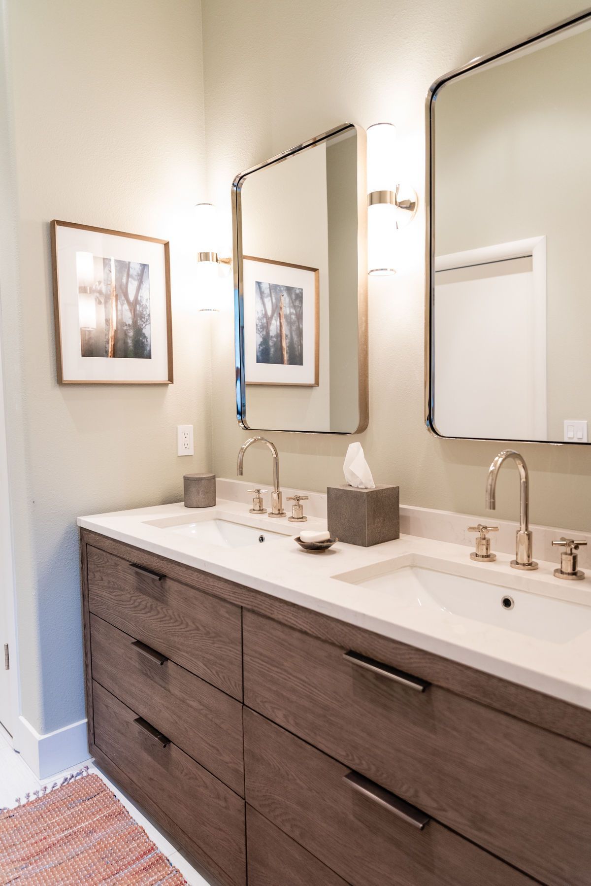 A bathroom with two sinks and two mirrors.