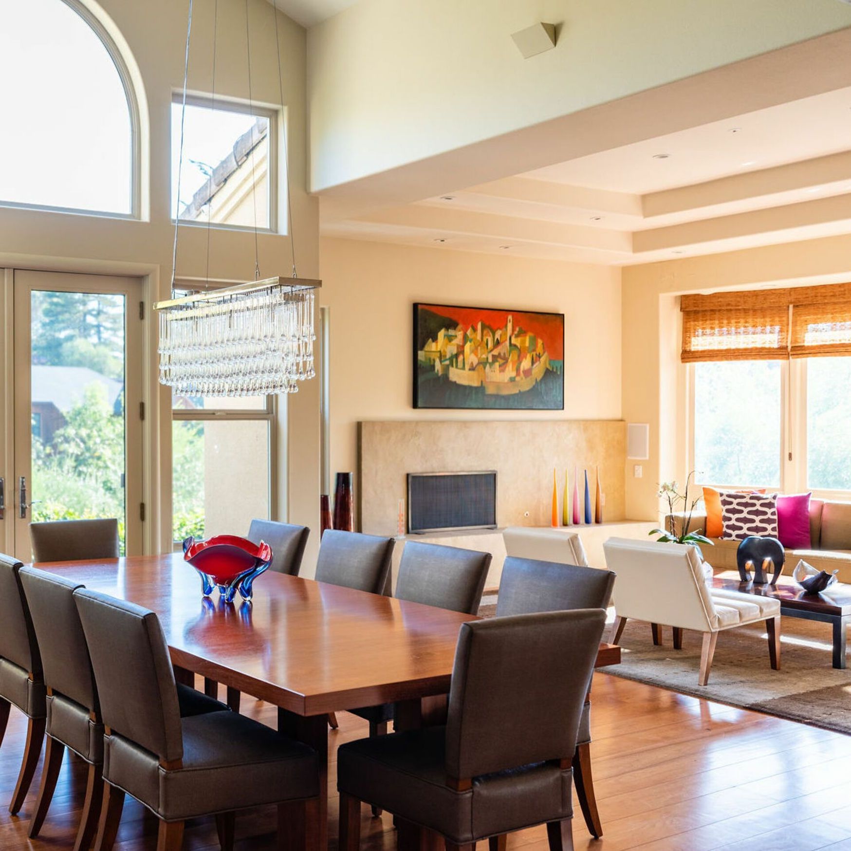 A living room with a table and chairs and a fireplace