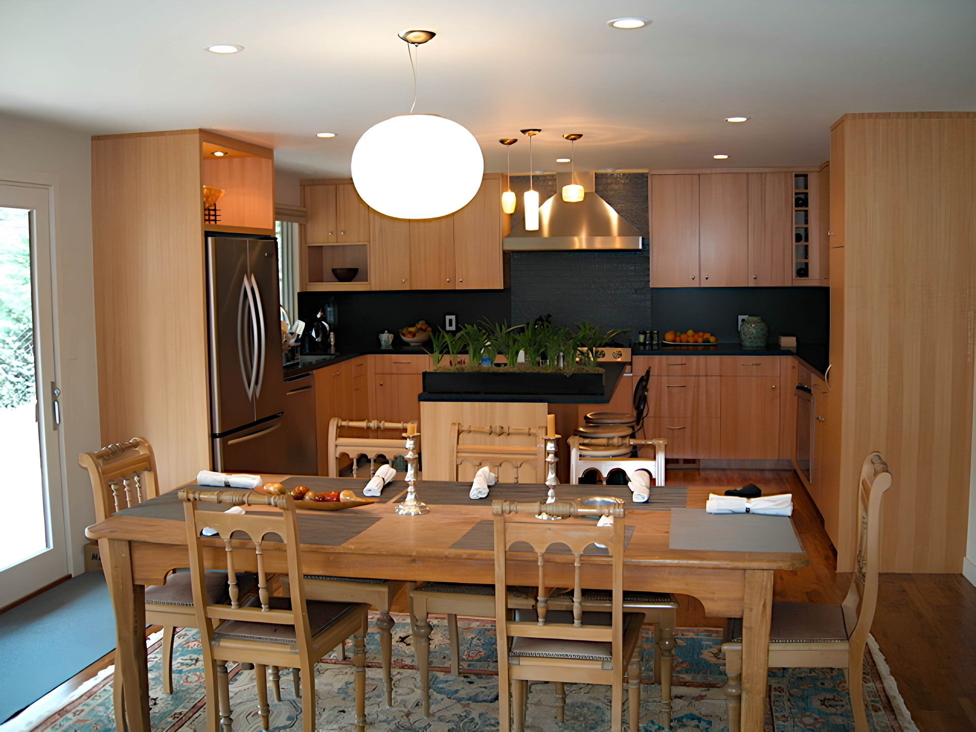 A kitchen with a table and chairs and a refrigerator