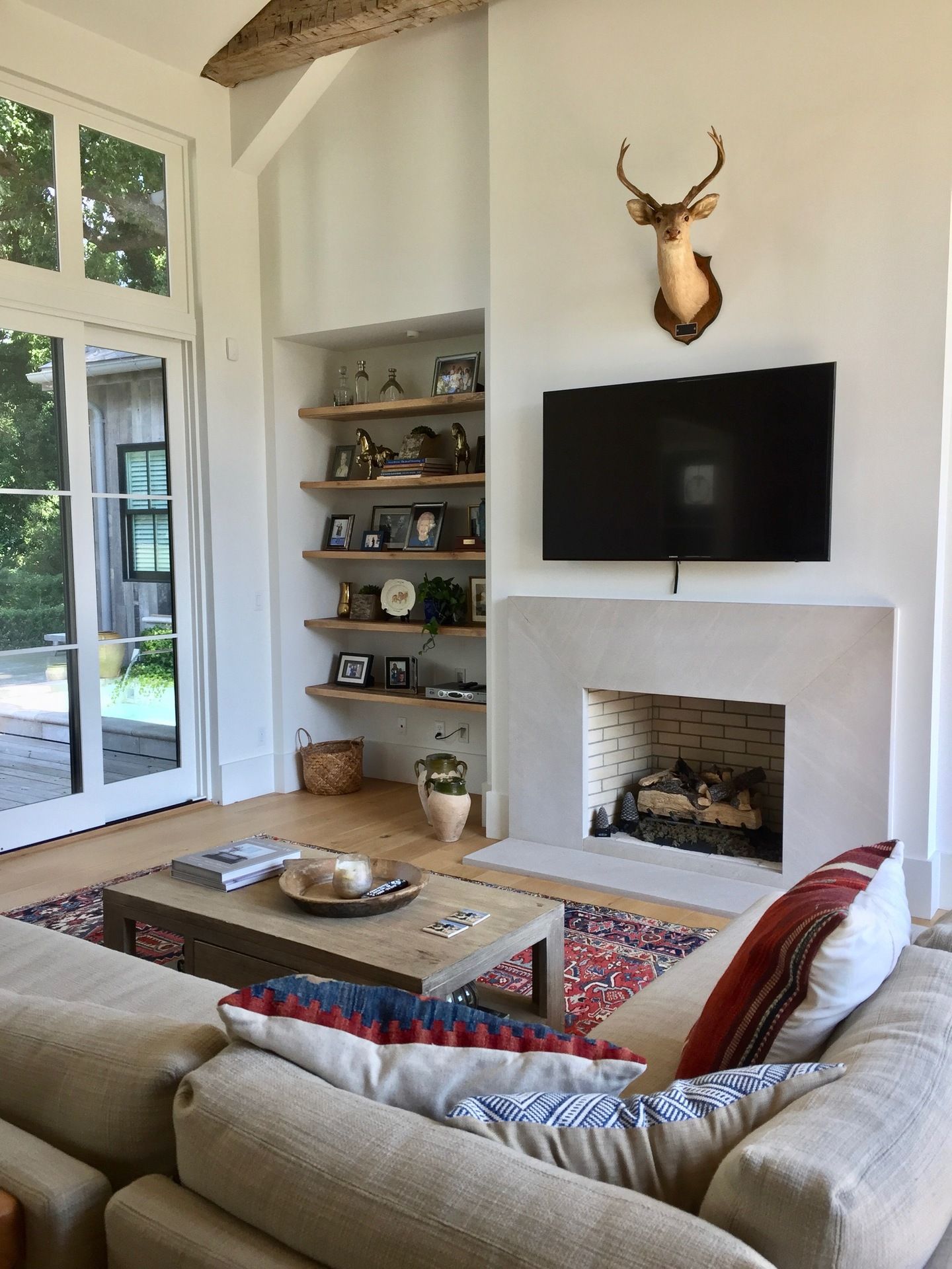 A living room with a fireplace and a flat screen tv
