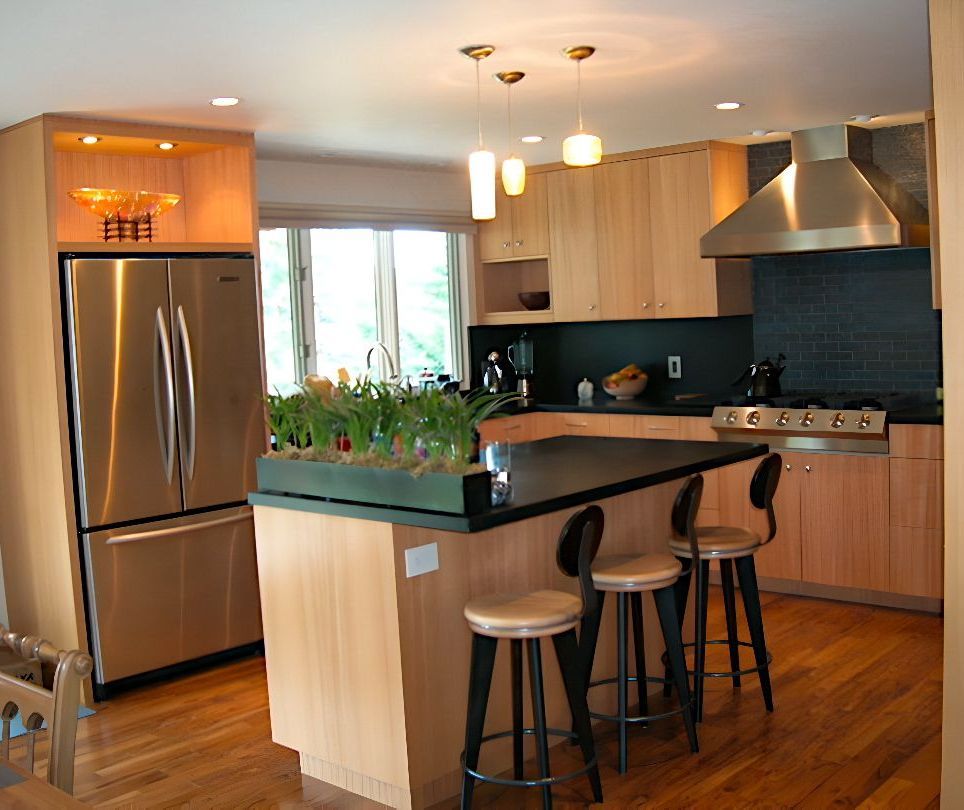 A kitchen with stainless steel appliances and wooden cabinets
