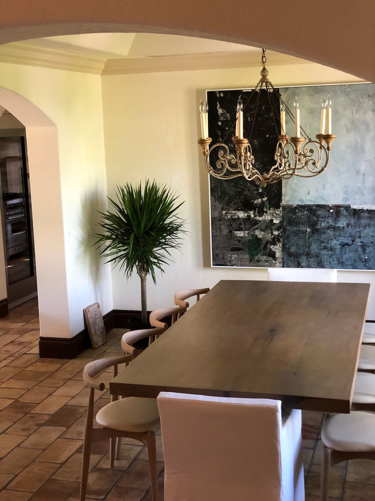 A dining room with a table and chairs and a chandelier