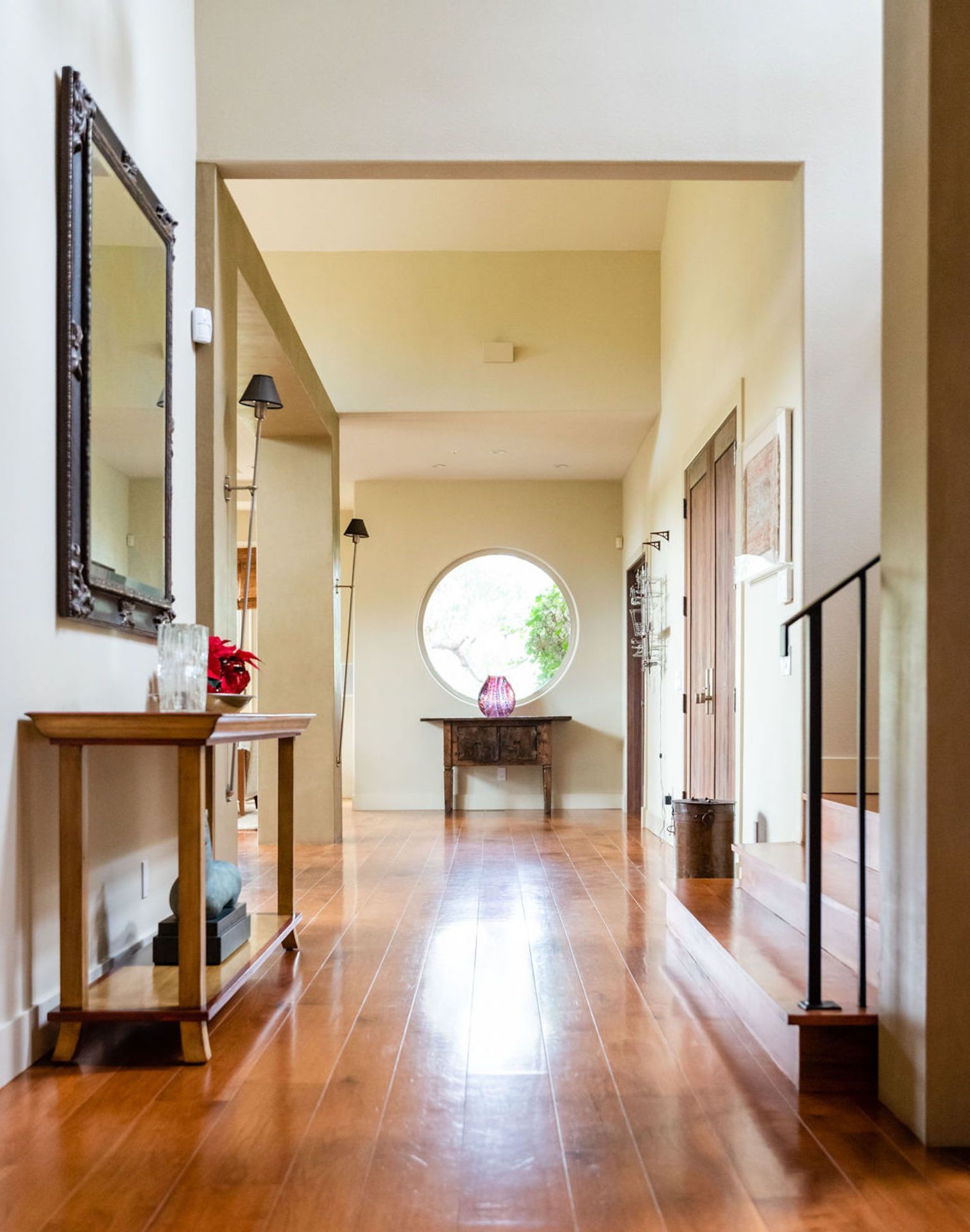 A hallway with a round window in the middle