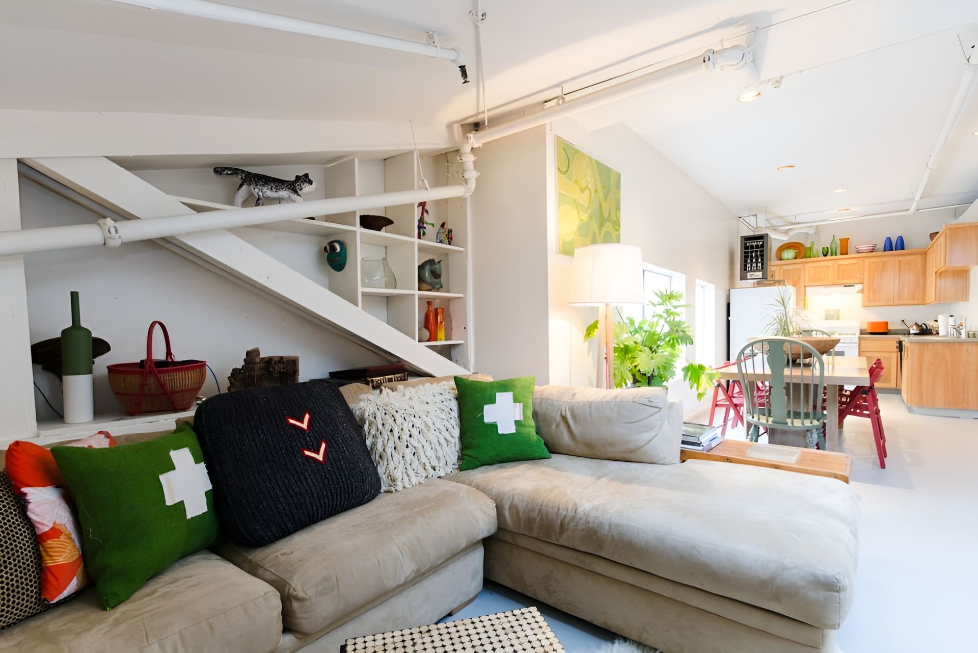 A living room with a sectional couch and pillows