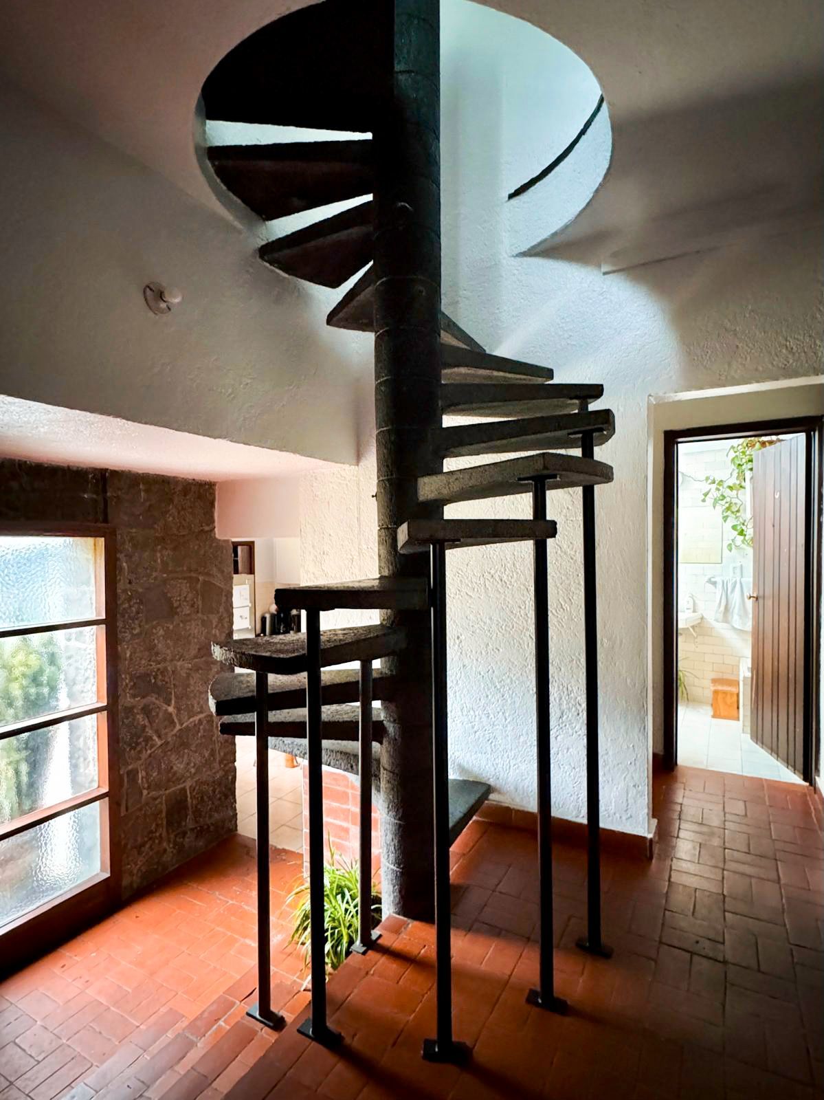 A large stone building with a blue sky in the background.