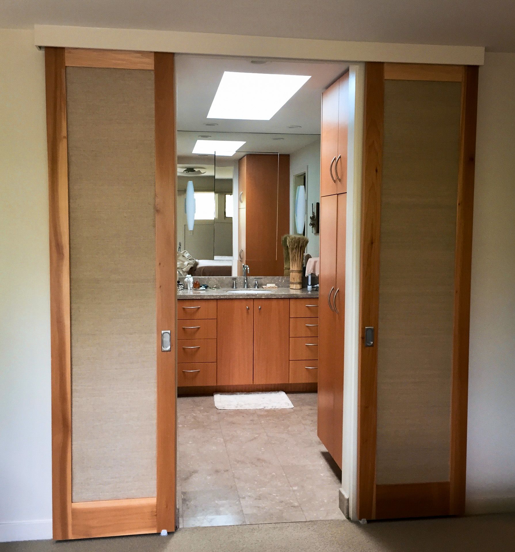 A bathroom with sliding doors leading to it