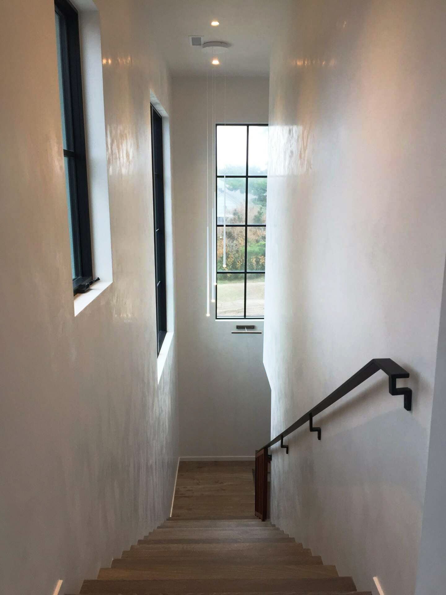 A staircase leading up to the second floor of a house with a window.