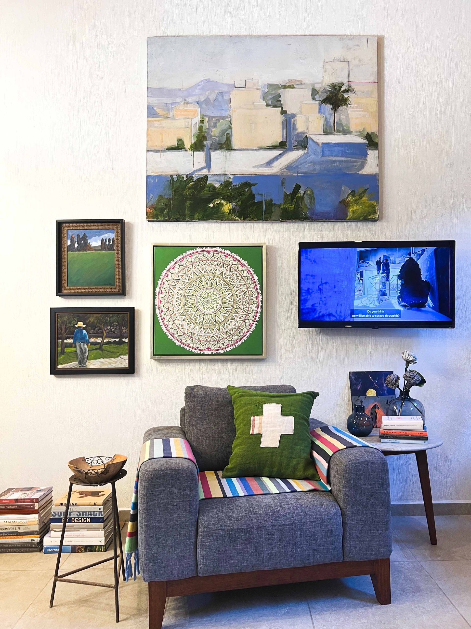 A living room with a chair and paintings on the wall