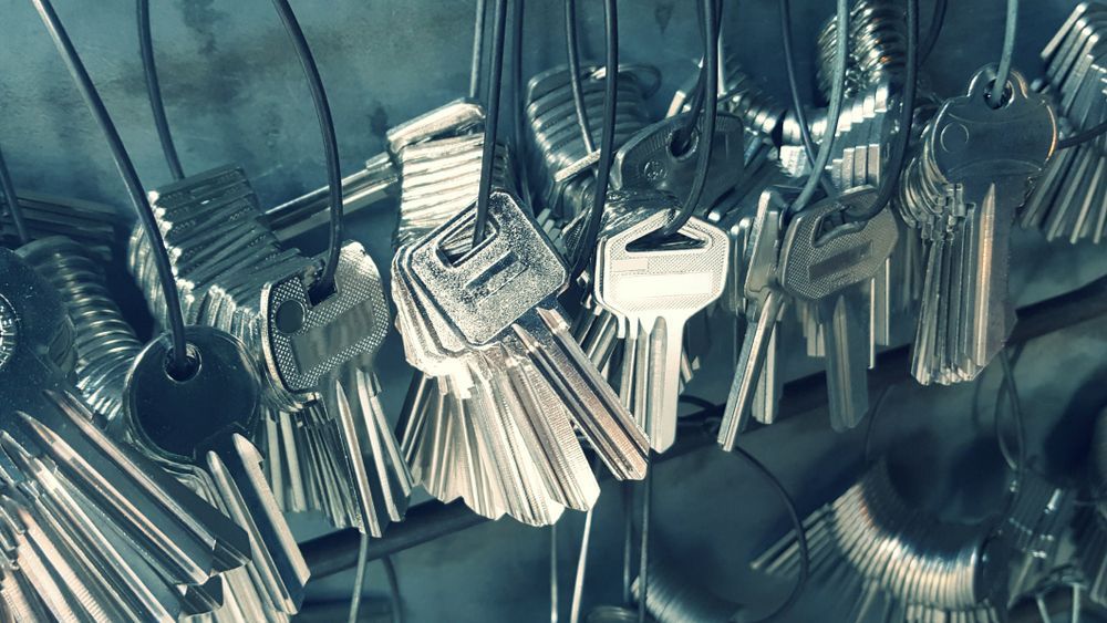 A Bunch of Keys Are Hanging From a Wire — Grace Locksmiths In Edmonton, QLD