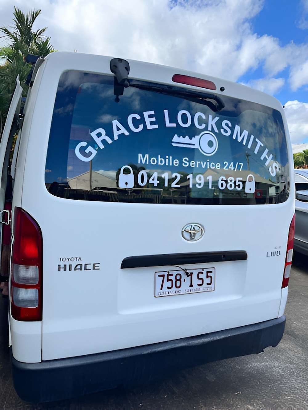 The Back Of A White Van Is Parked In A Parking Lot — Grace Locksmiths In Manoora, QLD