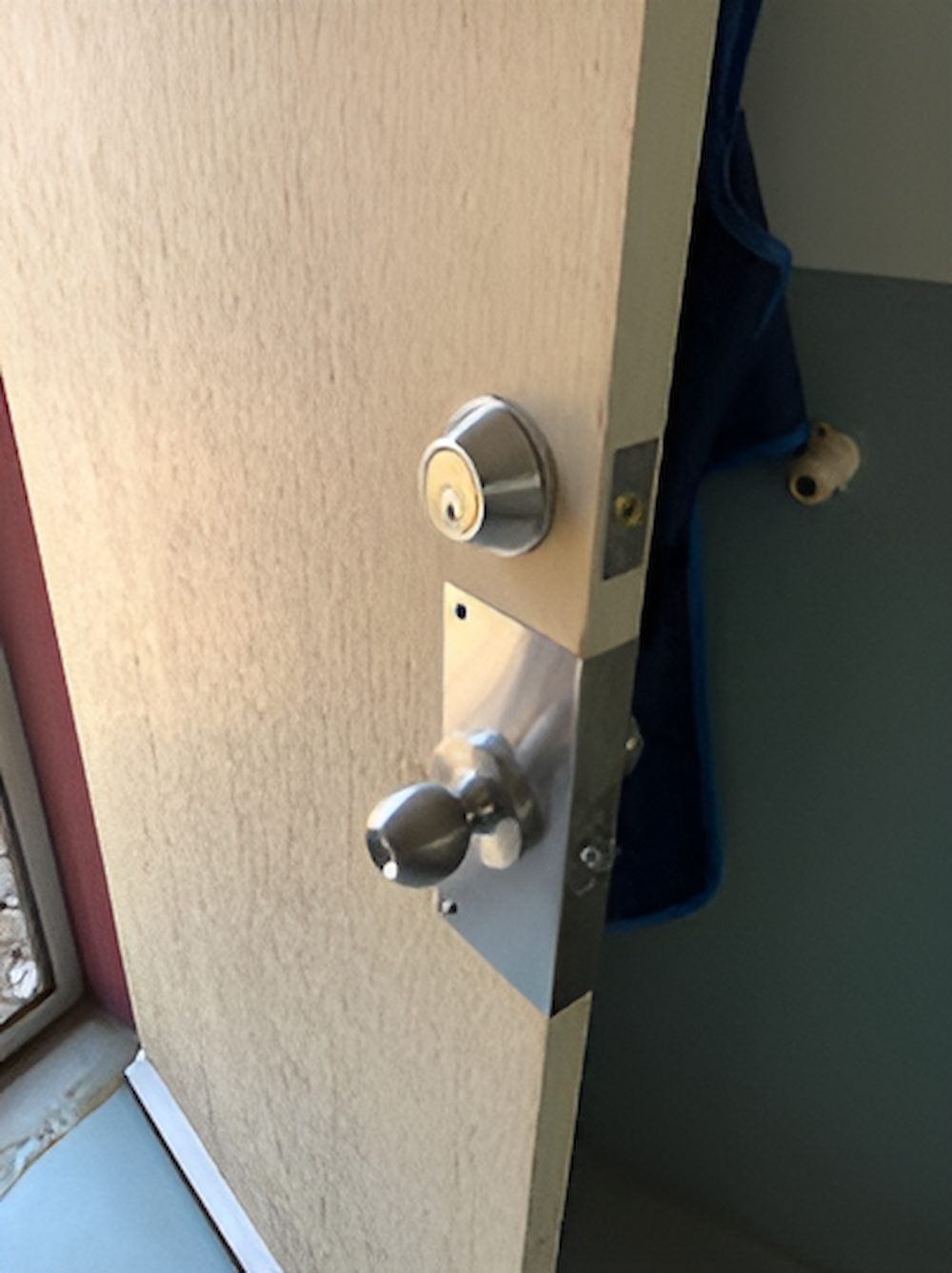 A Door With A Stainless Steel Door Knob On It — Grace Locksmiths In Manoora, QLD