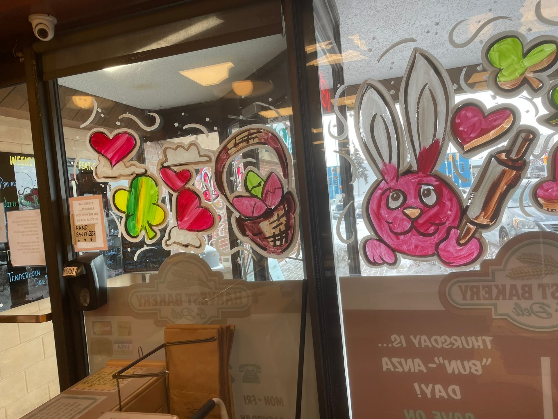 A bakery with a pink bunny and hearts painted on the windows.