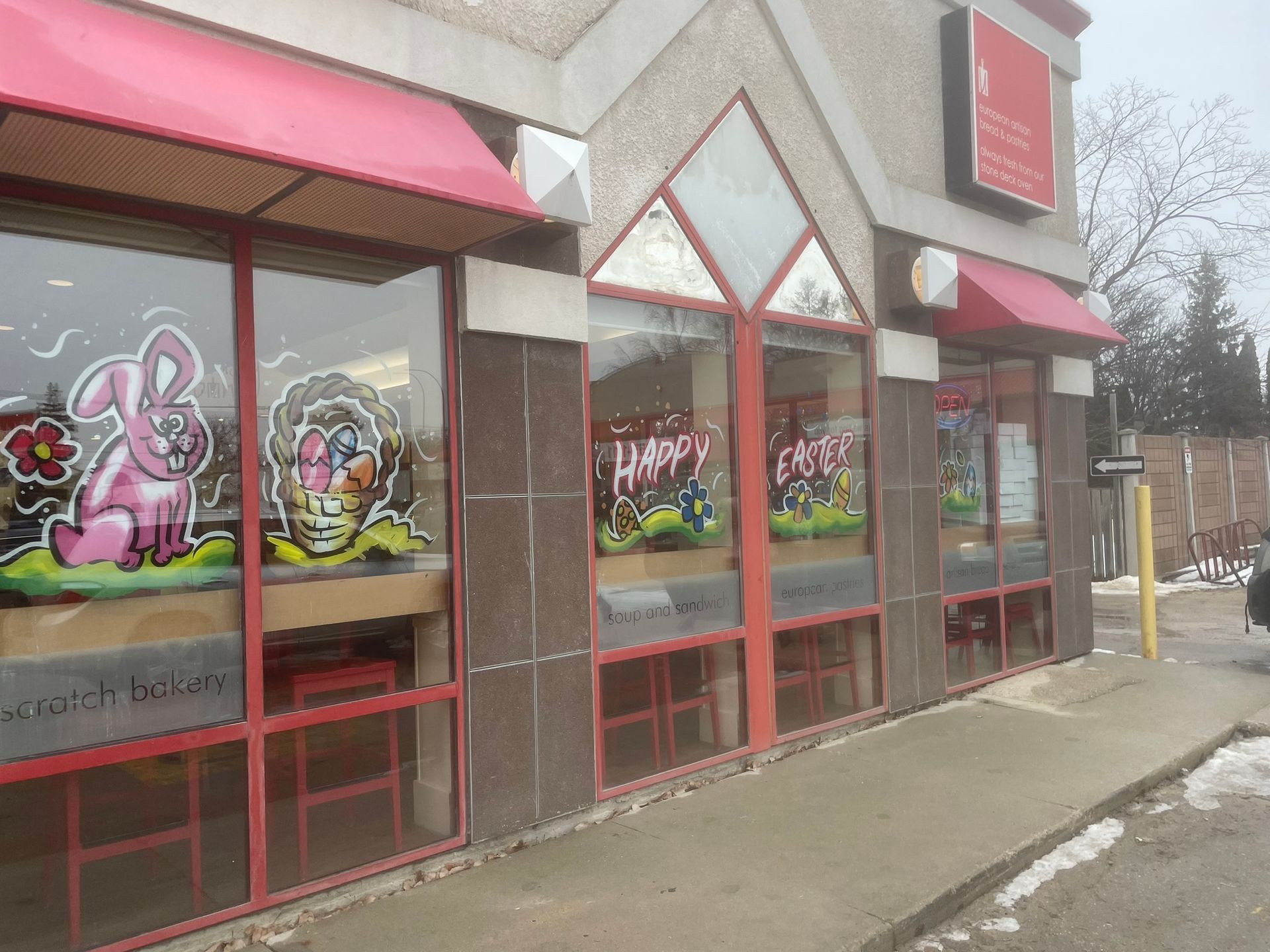 A restaurant with a pink bunny on the window.